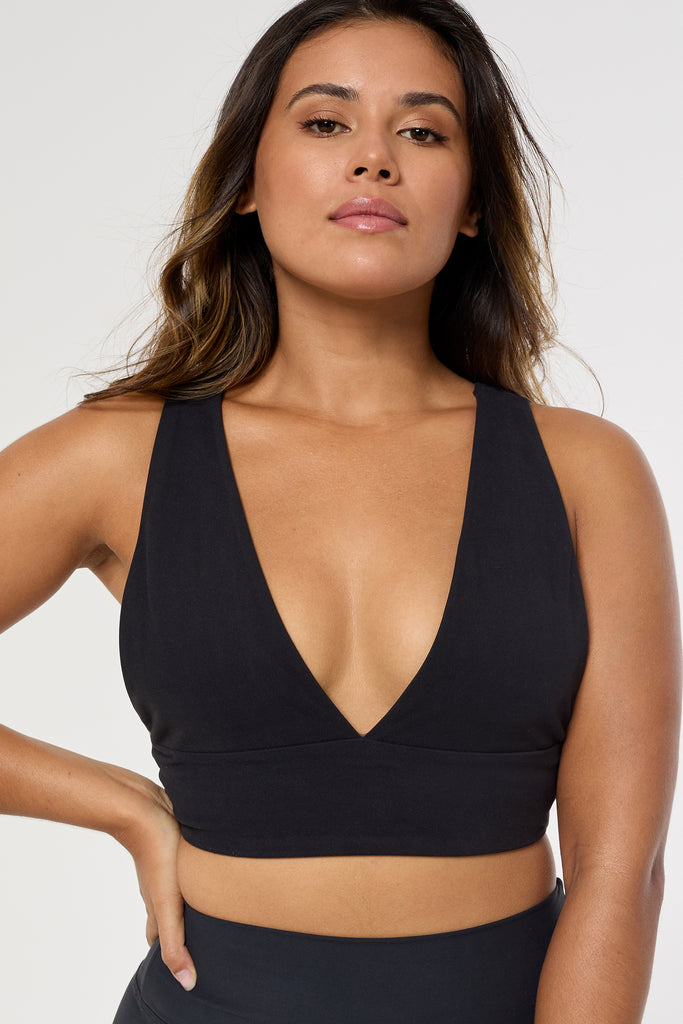 Black deep V-neck low-impact support with a seamless fit, removable padding for all-day comfort and style close up