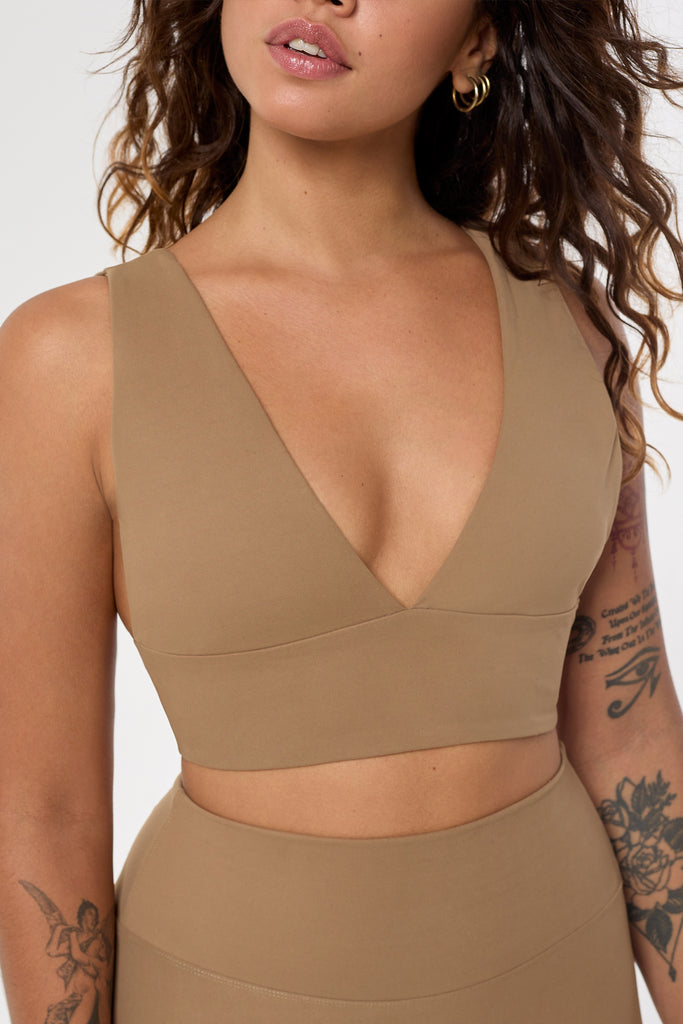 Light brown deep V-neck low-impact support with a seamless fit, removable padding for all-day comfort and style close up