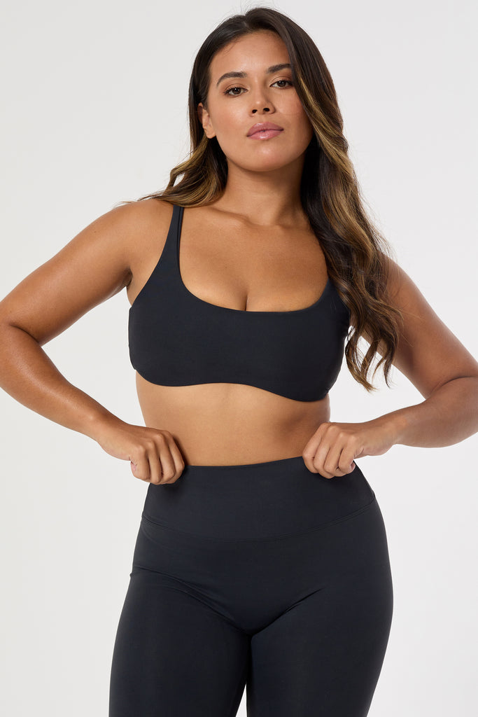 Black two in one reversible sports bra, medium-impact support with seamless fit, under-bust support, and removable padding