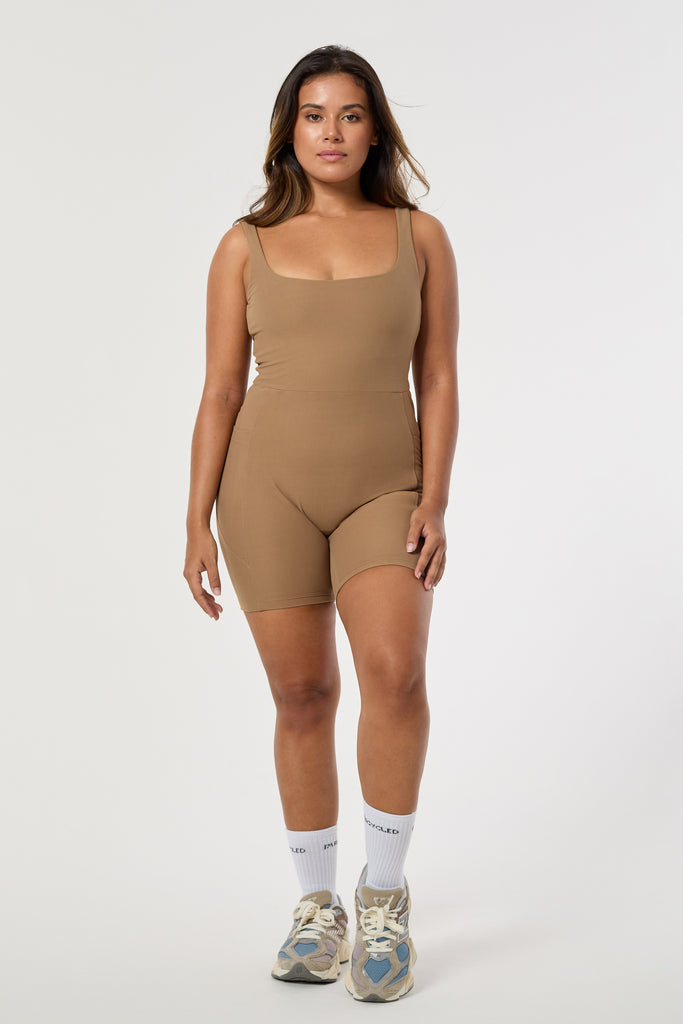 Light brown onesie with a cute square neckline, low back, high waist seam, and double side pockets. Perfect for every activity