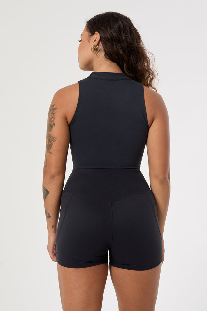 Cute black shorts: mid-high waisted with side pockets, V-shaped back seam, squat proof, no front seam, and double-layered waistband, back view