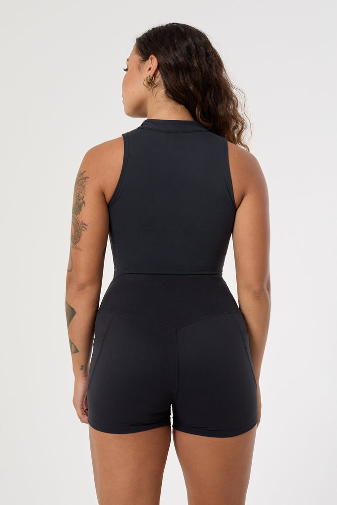 The perfect triple-layered black sports bra with removable cups and a front zip. Perfect for low-impact workouts, worn zipped or unzipped in and out of the gym, back view