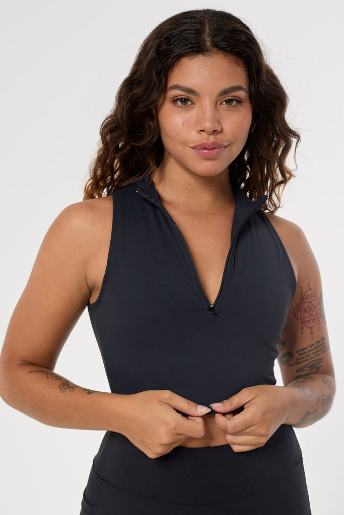 The perfect triple-layered black sports bra with removable cups and a front zip. Perfect for low-impact workouts, worn zipped or unzipped in and out of the gym, close up