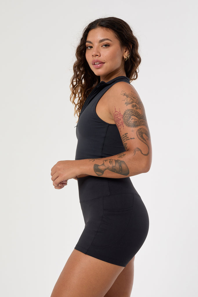 The perfect triple-layered black sports bra with removable cups and a front zip. Perfect for low-impact workouts, worn zipped or unzipped in and out of the gym, side view