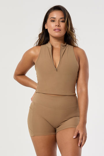 The perfect triple-layered light brown sports bra with removable cups and a front zip. Perfect for low-impact workouts, worn zipped or unzipped in and out of the gym