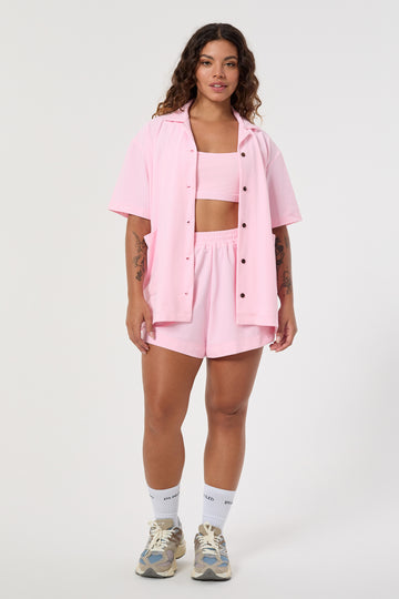 Light pink shirt in eco-friendly soft technical terry. Features coconut buttons, big pockets, and a lightweight feel.