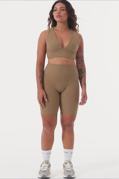 Light brown deep V-neck low-impact support with a seamless fit, removable padding for all-day comfort and style.