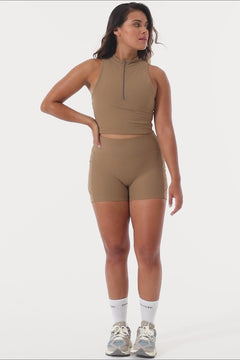 The perfect triple-layered light brown sports bra with removable cups and a front zip. Perfect for low-impact workouts, worn zipped or unzipped in and out of the gym