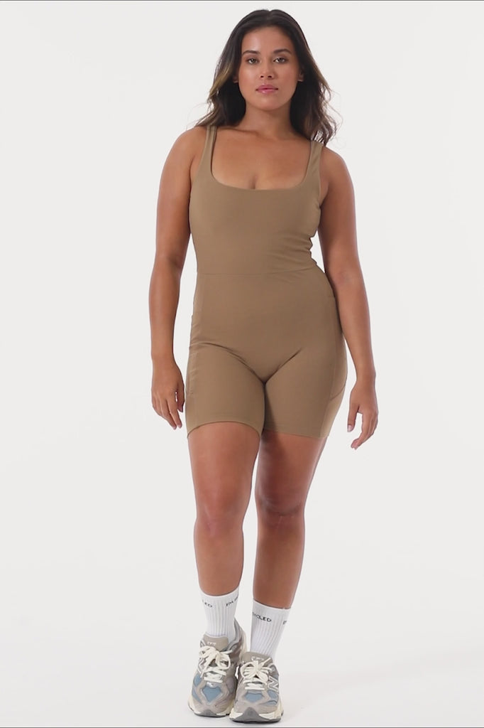 Light brown onesie with a cute square neckline, low back, high waist seam, and double side pockets. Perfect for every activity