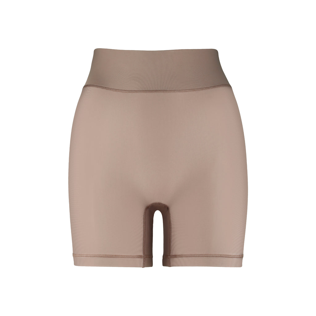 High-waisted beige bicycle shorts with a secure, compressive fit. No front seam and flattering wide waist band, ghost image front view