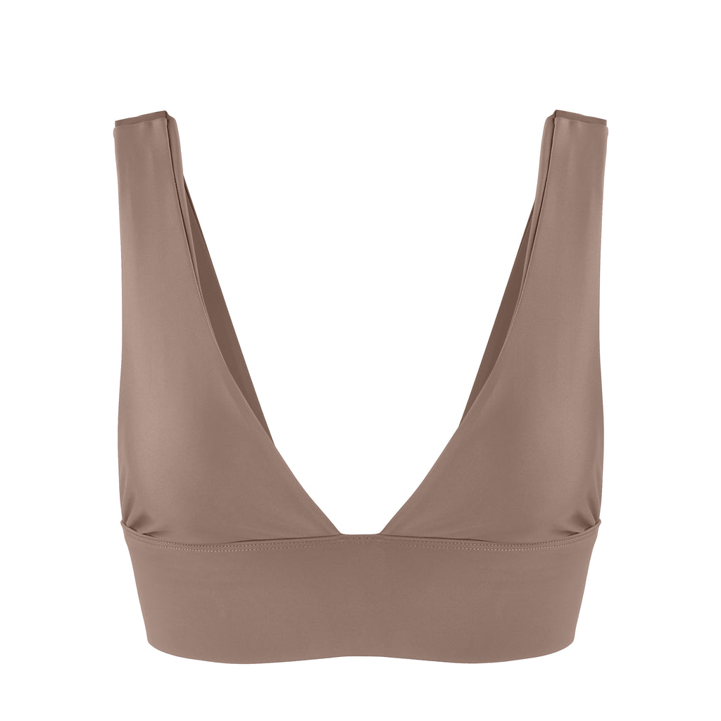 Classy and sexy sports bra in beige with low-impact support, seamless fit, removable padding, and a wide under-bust elastic band  ghost image front view