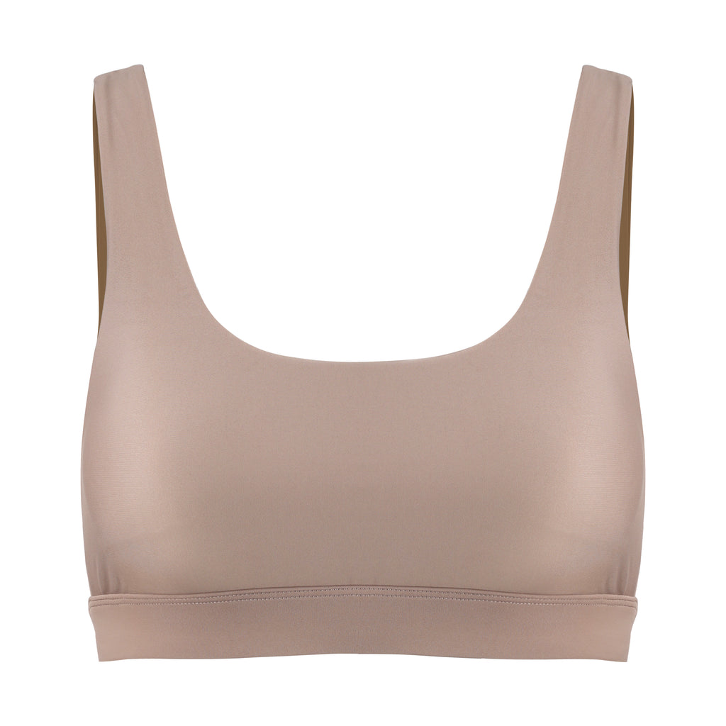 Beige classic sports bra with mid to high impact support, seamless fit that holds everything in place, removable padding, ghost image front view