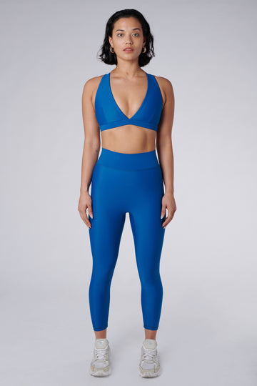 High-waisted blue leggings with a compressive waistband for a slimming, luxurious fit. Perfect for high-intensity activities.