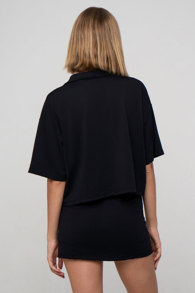 Black Boxy Polo Shirt with lightweight, airy sleeves for free movement, back view