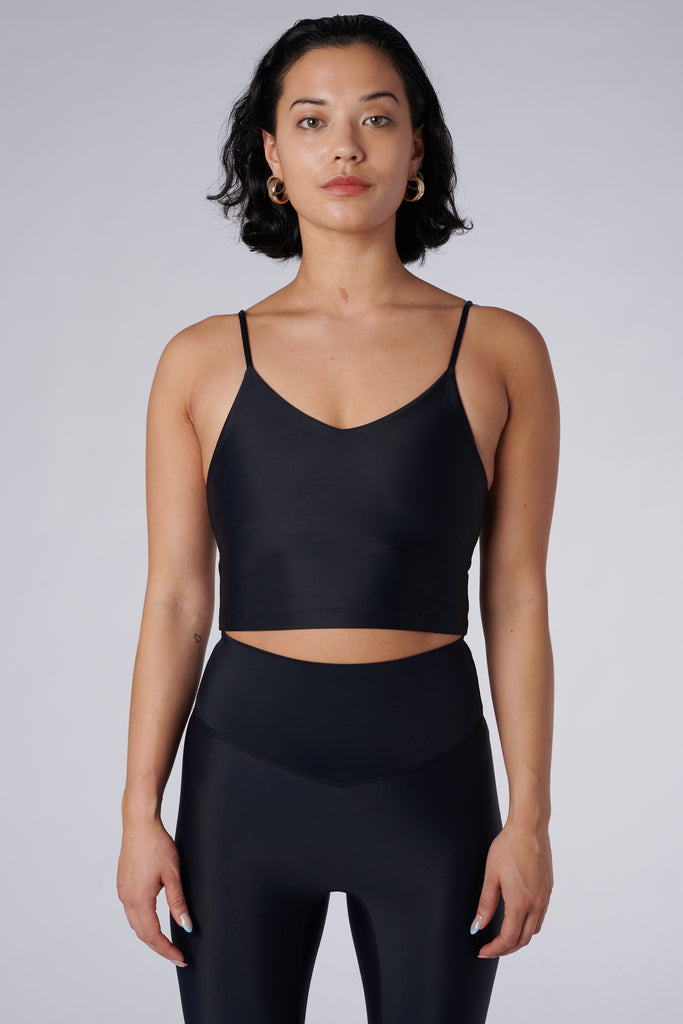 Black crop top with inbuilt bra for low-impact activities, seamless fit, removable padding, and adjustable straps. Comfortable for work or on the go, 