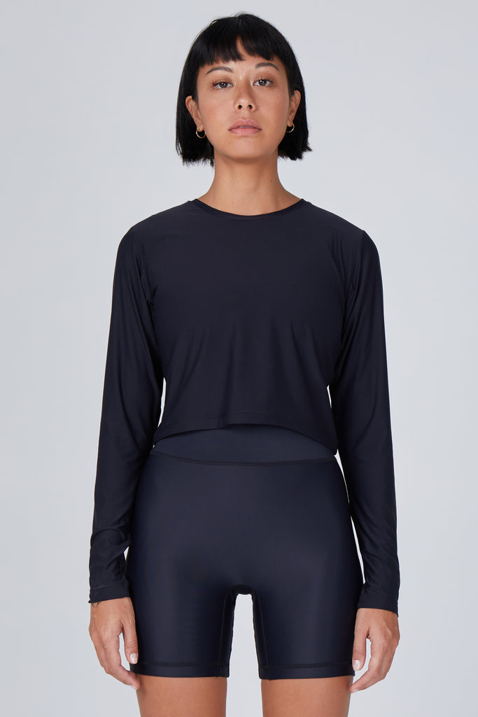 Ultra-lightweight, quick-drying long sleeve black crop top that fits like a second skin for comfort and UV protection front view