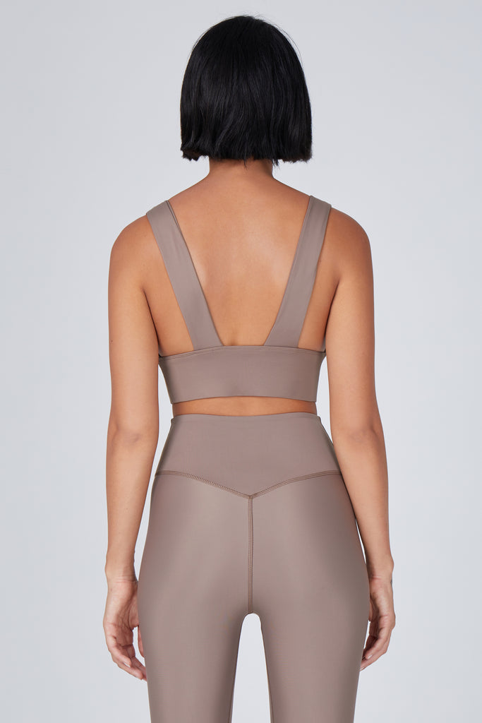 Classy and sexy sports bra in beige with low-impact support, seamless fit, removable padding, and a wide under-bust elastic band back view