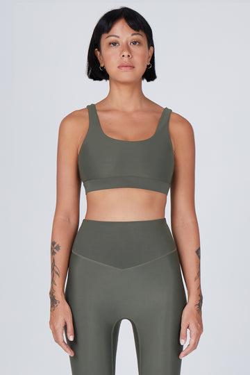 Olive green classic sports bra with mid to high impact support, seamless fit that holds everything in place, removable padding, front view