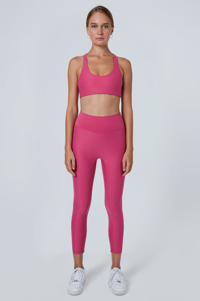 Super soft pink high-waisted 7/8 leggings without a front seam for all-day comfort. Perfect for non abrasive sports and everyday wear, front view