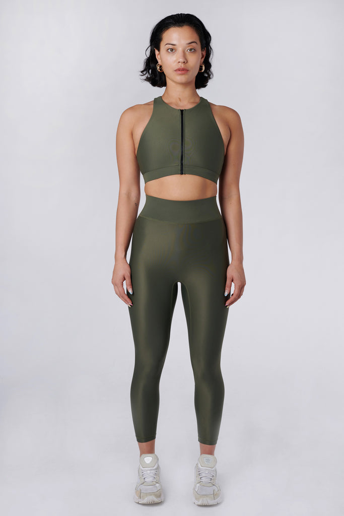High-waisted olive green leggings with a compressive waistband for a slimming, luxurious fit. Perfect for high-intensity activities, front view