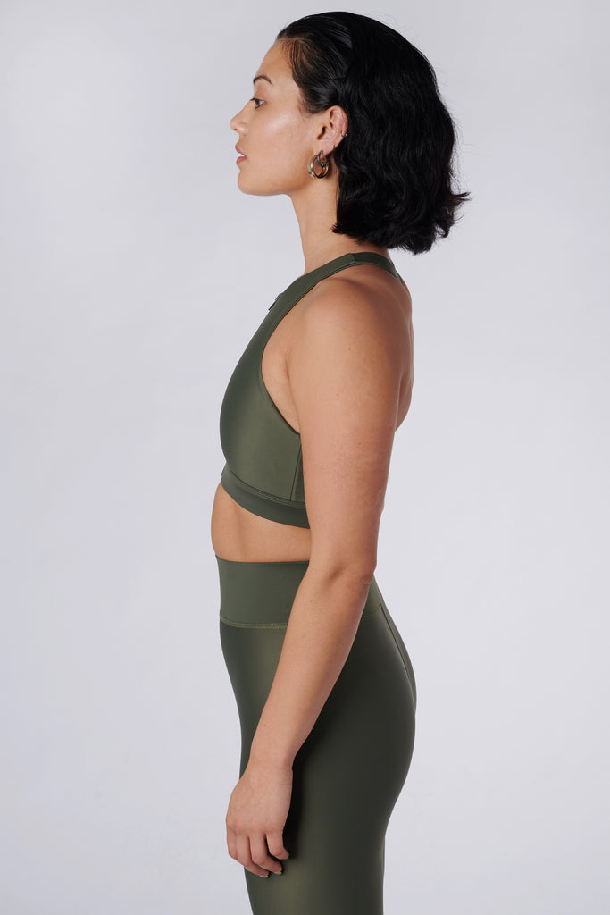 Easy to wear front zipped olive green crop top with low-impact support, removable padding and in-built sports bra, side view