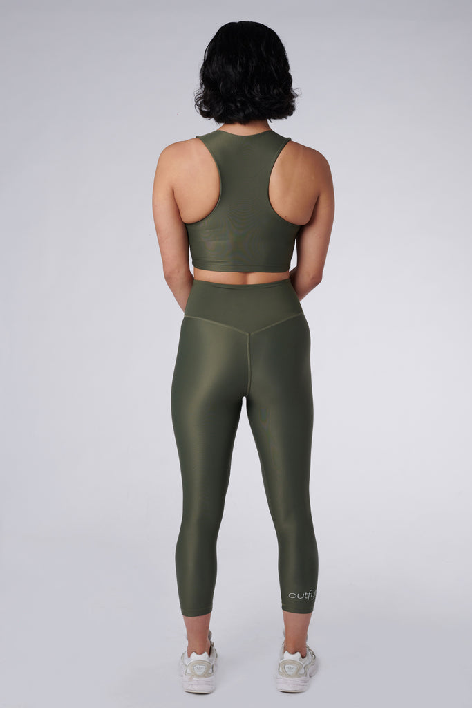 Versatile olive green 7/8 compressive leggings that fit like a glove and stay put during workouts. Squat proof and no front seam for ultimate comfort, back view