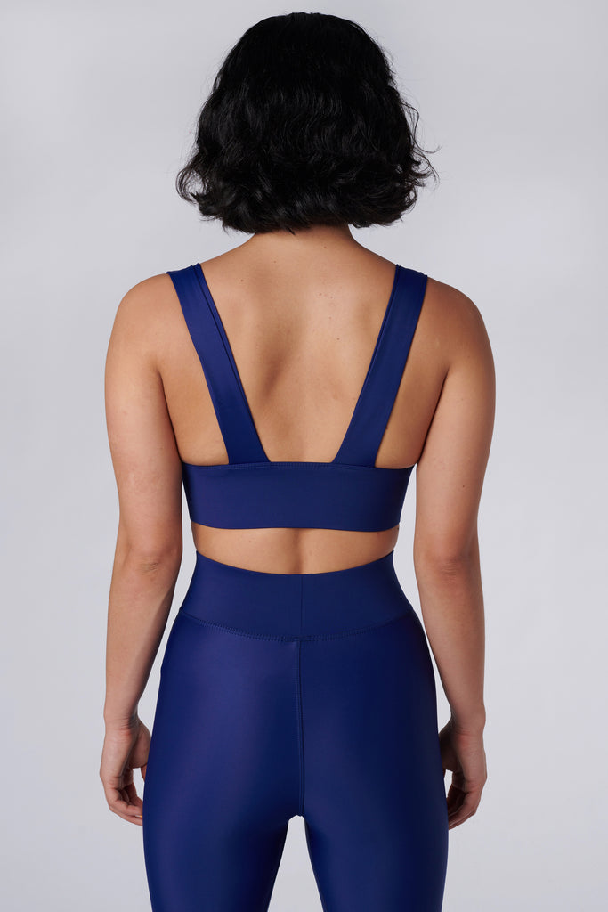 Classy and sexy sports bra in royal blue with low-impact support, seamless fit, removable padding, and a wide under-bust elastic band  back view