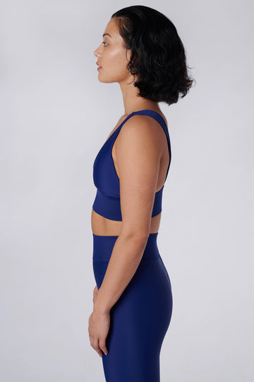 Classy and sexy sports bra in royal blue with low-impact support, seamless fit, removable padding, and a wide under-bust elastic band  side view