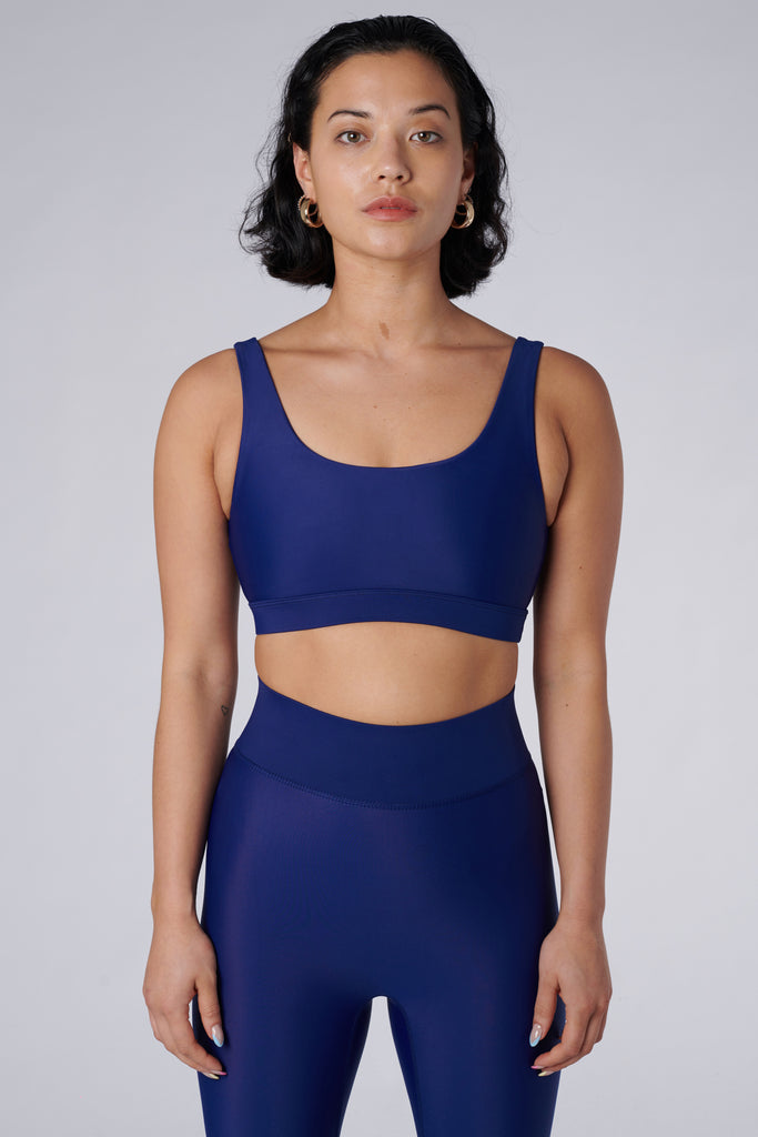 Navy blue classic sports bra with mid to high impact support, seamless fit that holds everything in place, removable padding, front view