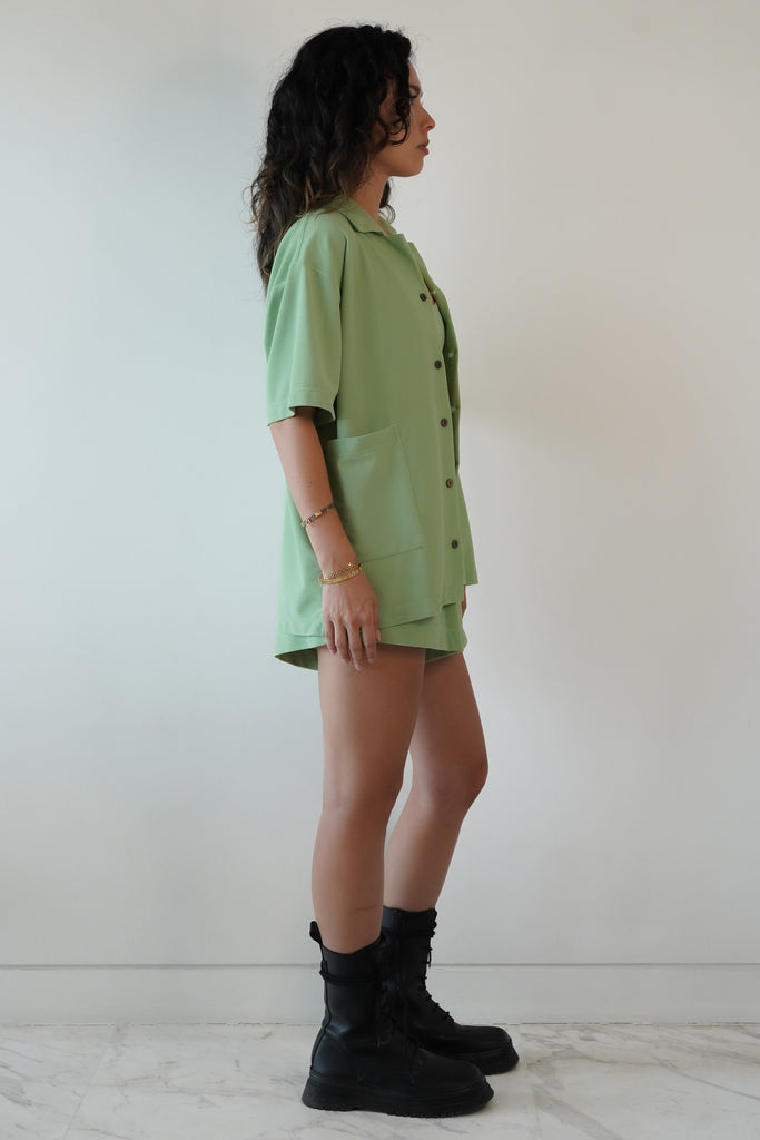 Mint green shirt in eco-friendly soft technical terry. Features coconut buttons, big pockets, and a lightweight feel, side view